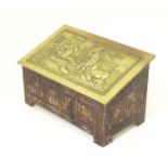 An early 20thC biscuit tin formed as a coffer with linen fold decoration, the pressed brass lid with