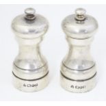 A pair of silver pepper grinders / pepper mills, hallmarked London 1987, maker M. C. Hersey & Son