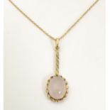 A pendant necklace set with rose quartz cabochon on a 9ct gold chain approx 18" long (matching to