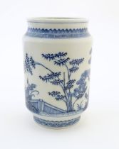 A Chinese blue and white vase of cylindrical form with garden terrace with trees and blossom