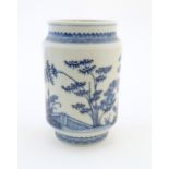 A Chinese blue and white vase of cylindrical form with garden terrace with trees and blossom