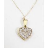 An American 10k gold necklace with heart formed pendant set with a diamond. The pendant Approx 1/