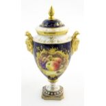 A Coalport twin handled lidded pedestal vase with hand painted decoration depicting fruit, apples,