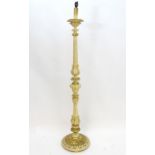 A mid - late 20thC Italian carved wood standard lamp with cream and gilt finish. Approx 65" high