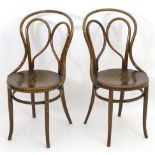 A pair of Thonet style Bentwood chairs with double bowed back rests and anthemion embossed seats.