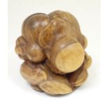 A large carved wooden sumo wrestler rolled in a ball. Approx. 11 1/2" high Please Note - we do not