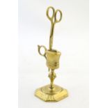 A 20thC brass candle snuffer / wick trimmer with stand. Approx. 7" high overall Please Note - we