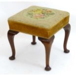 A 19thC mahogany footstool with a squared rectangular top above four cabriole legs terminating in