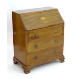 An early 20thC mahogany 'James Shoolbred' bureau, with a marquetry inlaid fall front above three