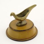 A 20thC brass pipe rest / stand modelled as a bird on a circular base. Approx. 3 1/4" high overall