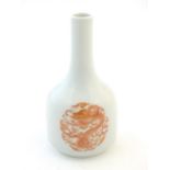 A Chinese bottle vase decorated with dragons and the flaming pearl amongst stylised clouds.