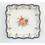 A Royal Worcester dish of squared form with central floral decoration to centre and swag border.