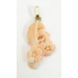A carved coral coloured pendant with floral detail. Approx 1" long Please Note - we do not make