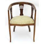 An Edwardian walnut tub chair with decorative stringing and three pierced back splats. 22" wide x