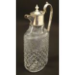 A glass claret jug of ovoid form with silver plate mounts and handle. Approx. 11 /2" high Please