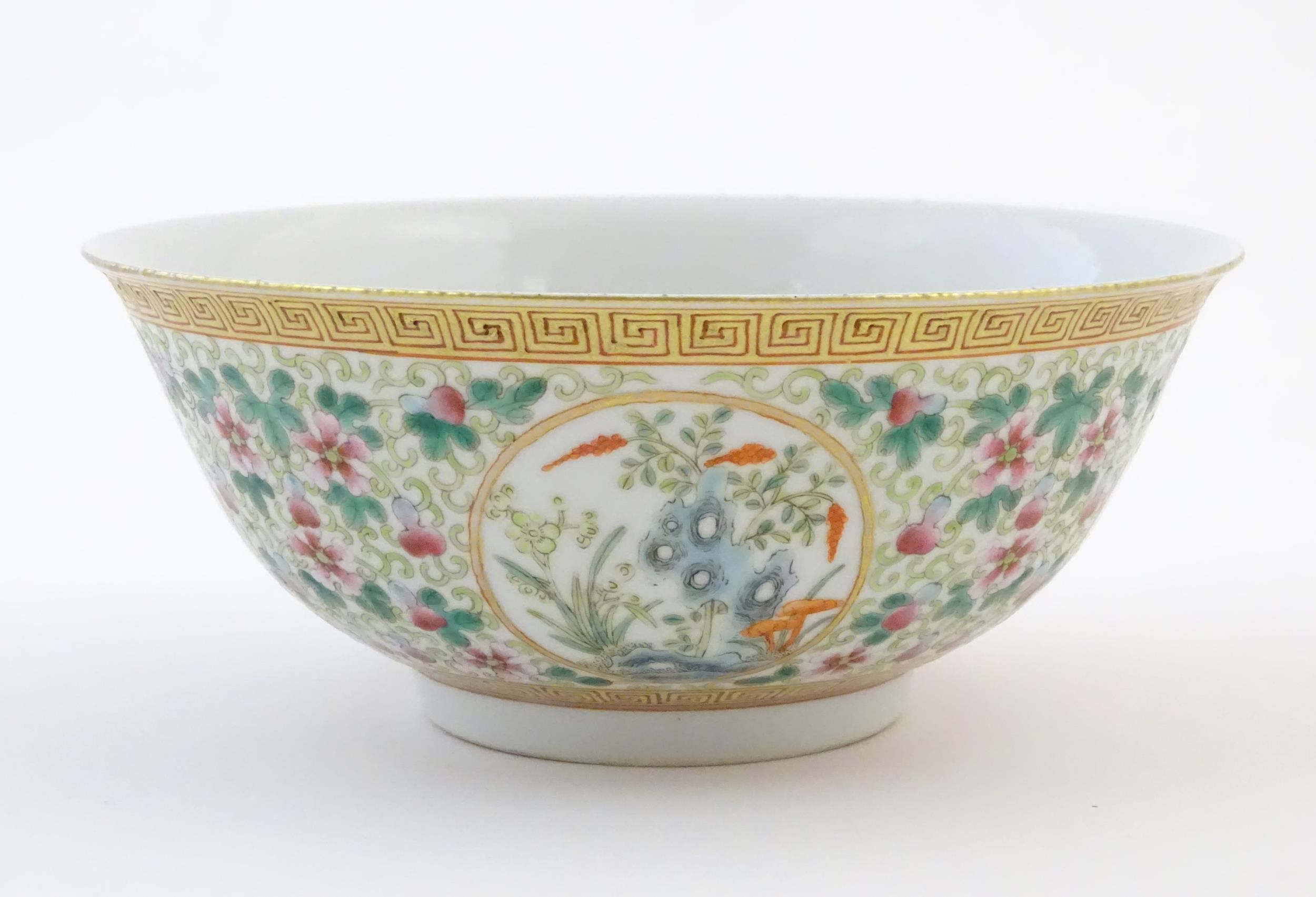 A Chinese famille verte bowl decorated with fruiting trees and landscapes scenes in roundels and - Image 3 of 6