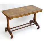 A Victorian burr walnut end table with a rectangular top, shaped ends, feet and having turned