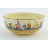 An Art Deco bowl, the outer decorated with floral detail depicting tulips, daffodils, etc. Marked