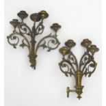 Two late 19th / early 20thC cast brass wall candelabras with scrolling floral and foliate