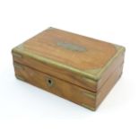 An early 20thC walnut table top cigarette box with brass mounts. Approx. 3" x 7 1/4" x 5" Please