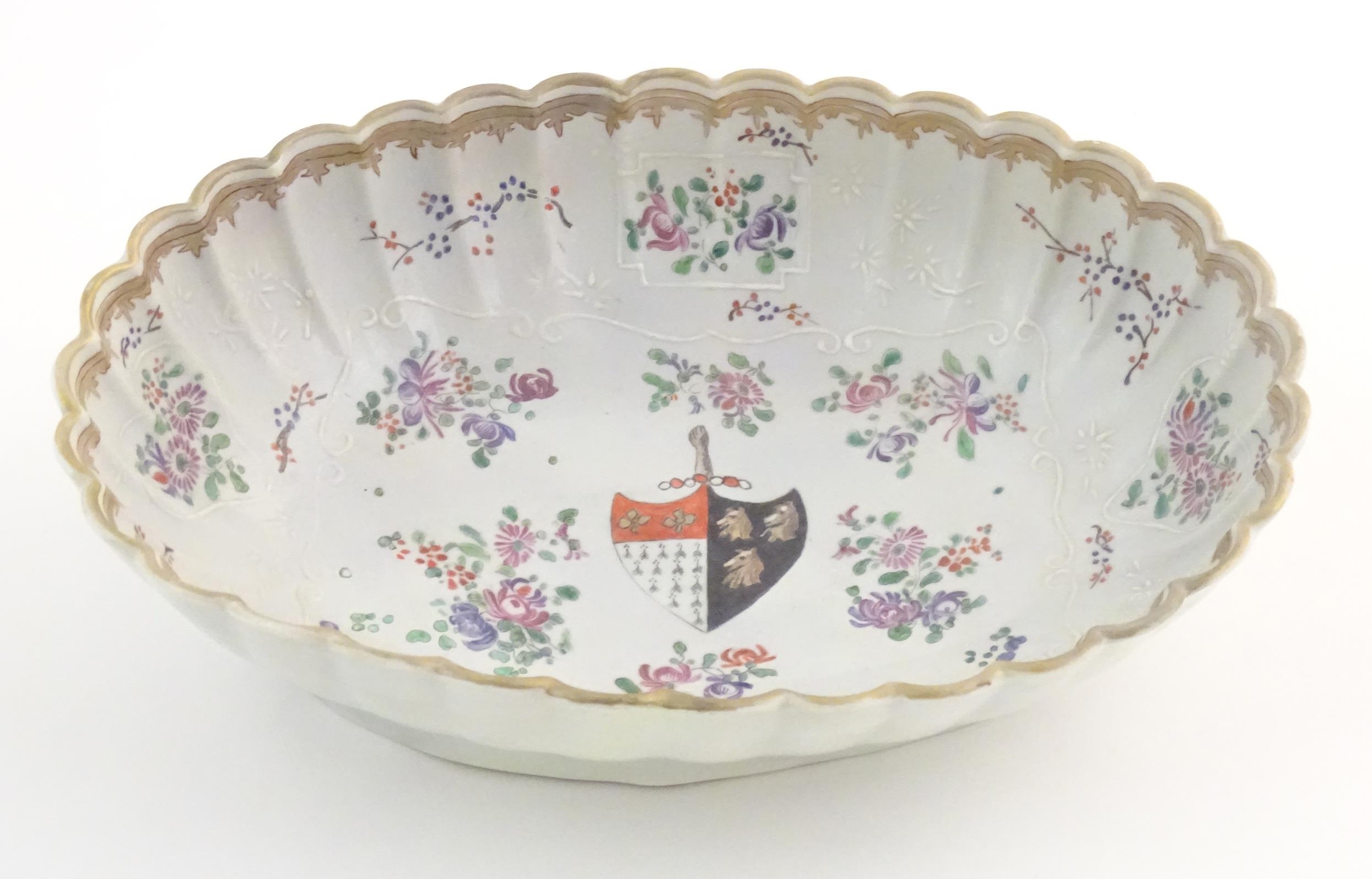 A Chinese export bowl of oval form with scalloped edge, decorated with flowers, foliage and armorial - Image 2 of 7