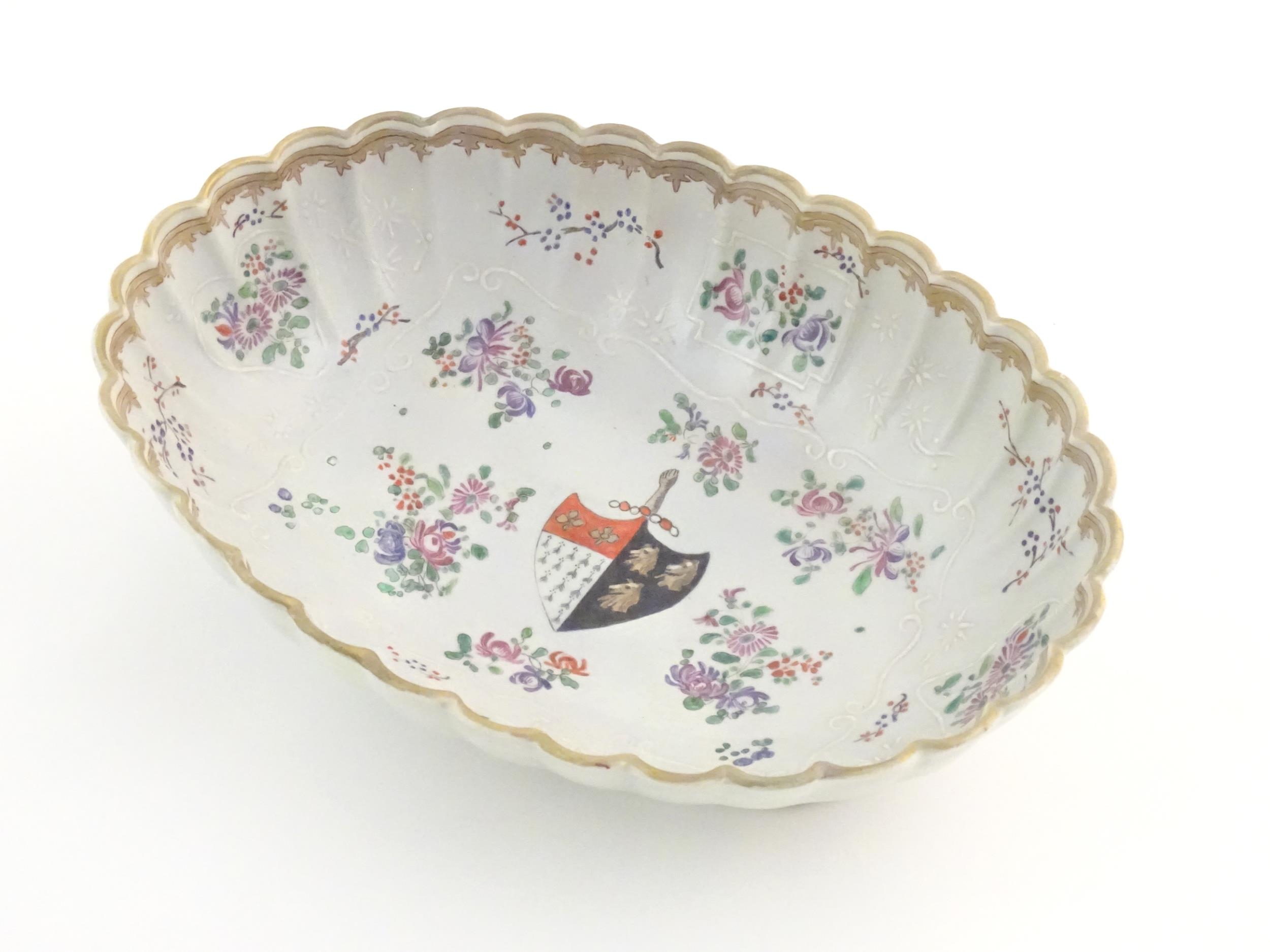 A Chinese export bowl of oval form with scalloped edge, decorated with flowers, foliage and armorial - Image 3 of 7