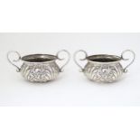 A pair of Victorian silver salts with twin handles and embossed decoration hallmarked London 1917,