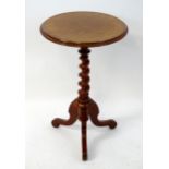 A 19thC mahogany tripod table with a circular moulded top above a spiral turned column and three