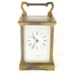 A brass five glass carriage clock, the white enamel dial with Roman numerals and inscribed 'Jean