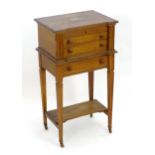 An early 20thC oak canteen with a lifting lid showing a fitted interior above two fitted drawers and