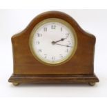 A 20thC mantle clock with French movement. 7 1/2" wide Please Note - we do not make reference to the