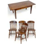 A hardwood kitchen table and four Windsor style chairs with lathe backs and raised on turned