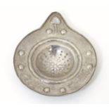 An Arts & Crafts white metal lemon strainer with hammered detail. Approx. 5" long Please Note - we