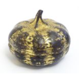 An Oriental lacquered pot and cover modelled as a gourd with gilt highlights. Approx. 3" high Please
