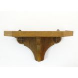 A mid 20thC carved oak wall shelf with carved cruciform with canted corners. 15 1/2" wide x 8" high.