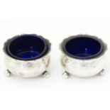 A pair of Victorian silver salts with blue glass liners, hallmarked Birmingham 1899, maker Thomas