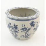 A Chinese blue and white planter / jardiniere with floral and foliate detail, the interior decorated