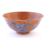 A Chinese bowl with a red ground decorated with vine leaves and gourds. Character marks under.