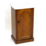 A late 19thC marble top cabinet with an arched panelled door and a turned wooden handle. 16 1/2"