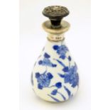A small Chinese blue and white vase with hand painted floral decoration with a silver collar,
