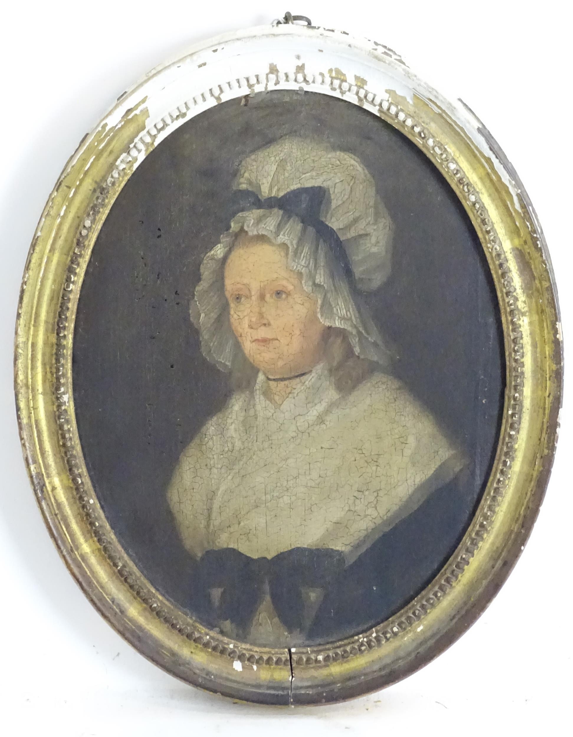 19th century, English School, Oil on paper laid on oval panel, A portrait of a woman wearing a