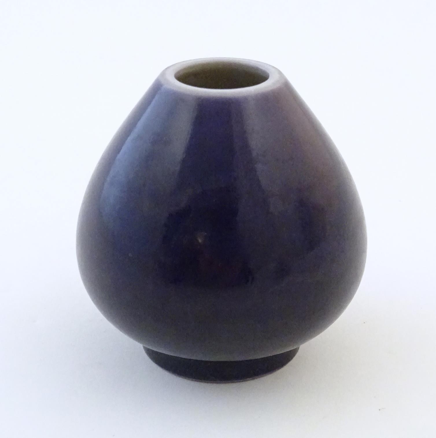 A small Chinese pot of teardrop form with an indigo glaze. Character marks under. Approx. 2" high - Image 3 of 6