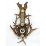 A 20thC German Black Forest combination Barometer & Thermometer, decorated with Fallow and Roe