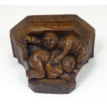 An early 19thC carved oak misericord / bracket depicting a man being flogged with a paddle.