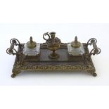 A Victorian cast brass standish / inkwell of rectangular form with twin scrolling handles and floral
