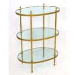 A 19thC three tier glass and gilt metal whatnot with oval tiers and reeded supports. 26" wide x