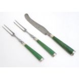 Three items of 19thC cutlery comprising two forks and a knife with green stained ivory handles.
