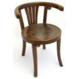 An early 20thC Thonet style bentwood chair with a curved backrest, pierced central splat and an