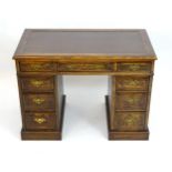 A late 19thC / early 20thC oak double pedestal desk with an inset leather top above one long