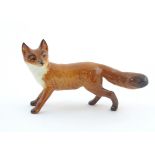 A Beswick model of a standing fox, model no. 1440. Marked under. Approx. 2 1/2" high Please Note -